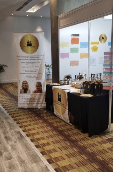 Exhibitor stand at The Social Work Show 2025 A display table with a banner, promotional materials, and a welcoming interior setting.